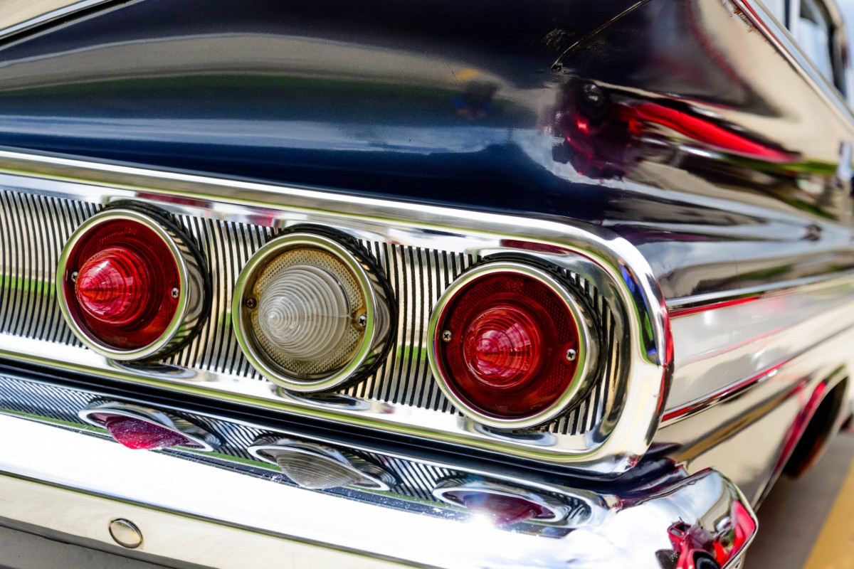 Tail lights on bumper of older car