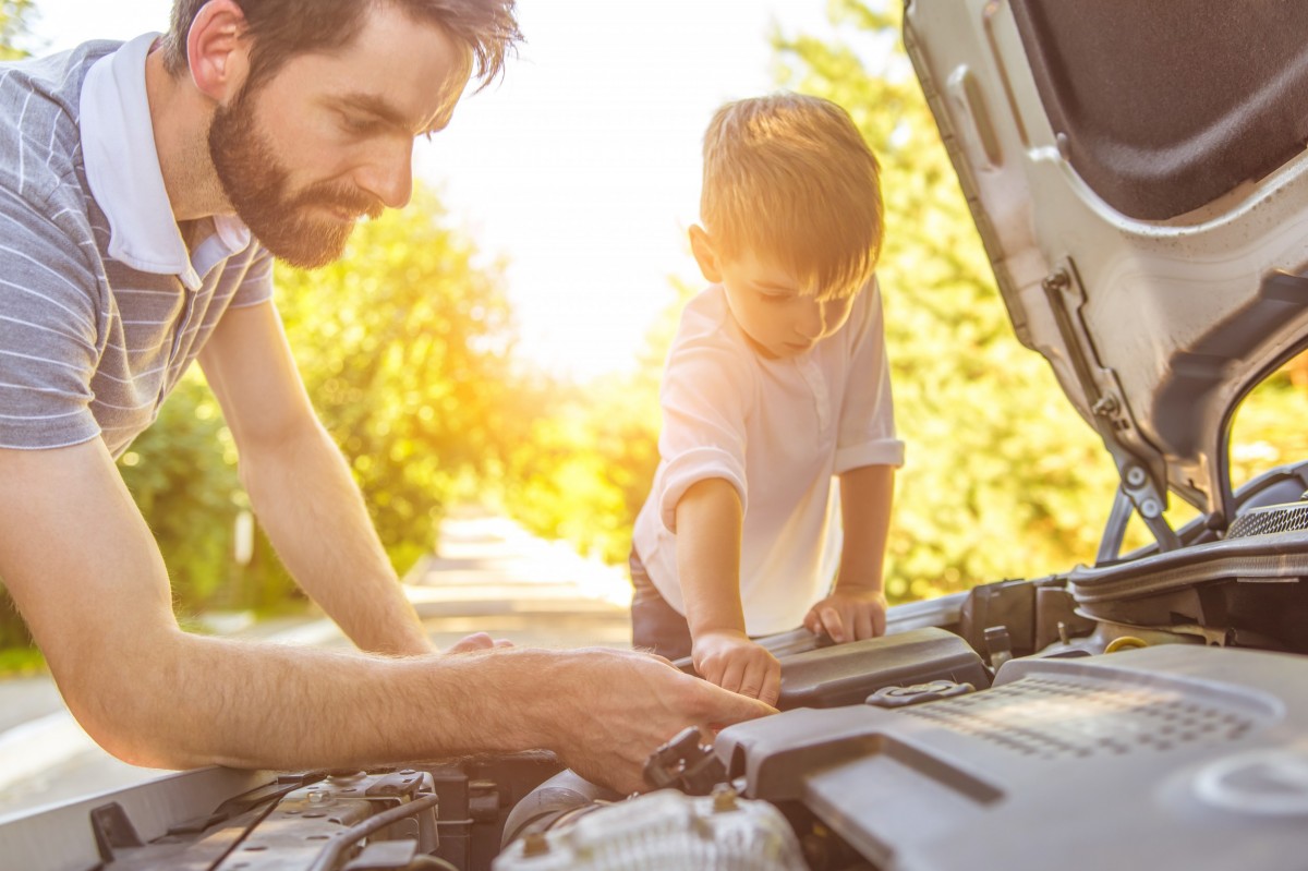 Man working under the hood of his vehicle