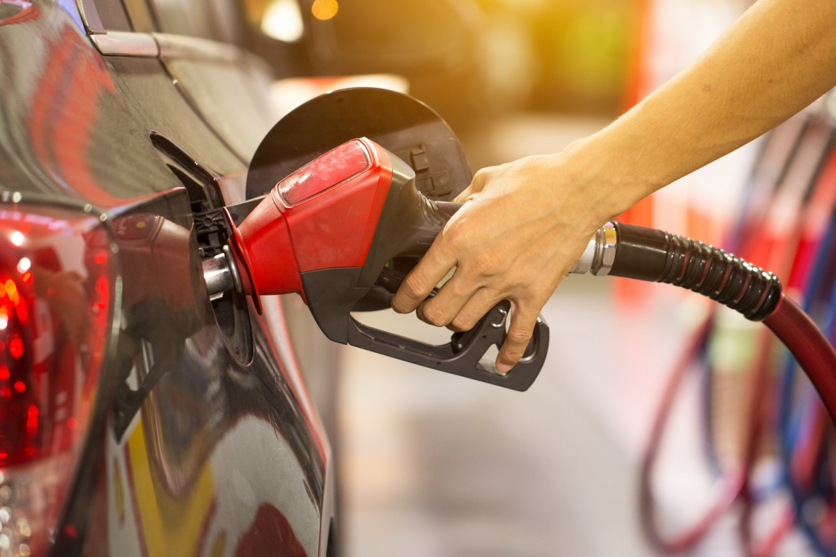 gas pump putting fuel into vehicle