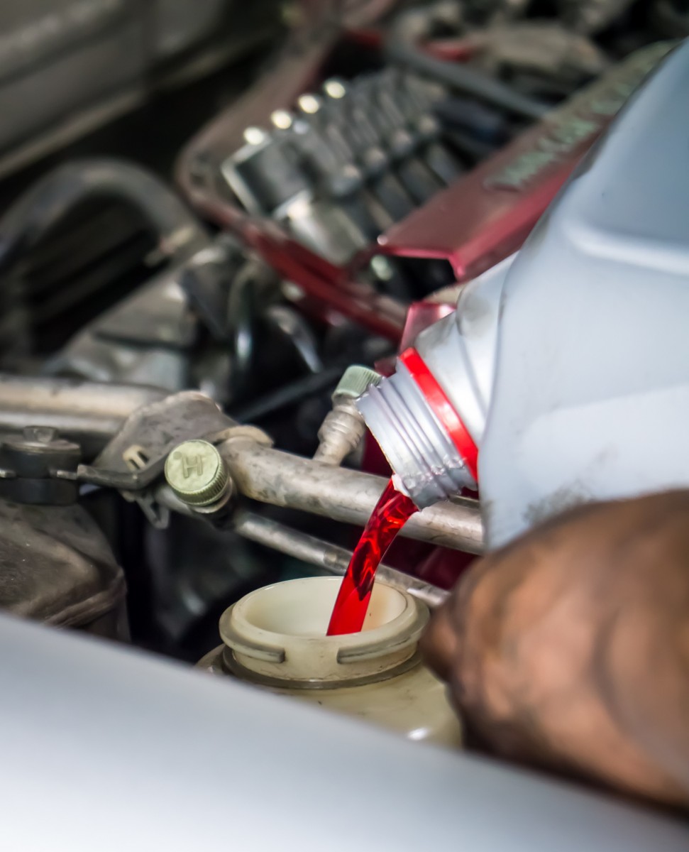 transmission fluid being poured into vehicle