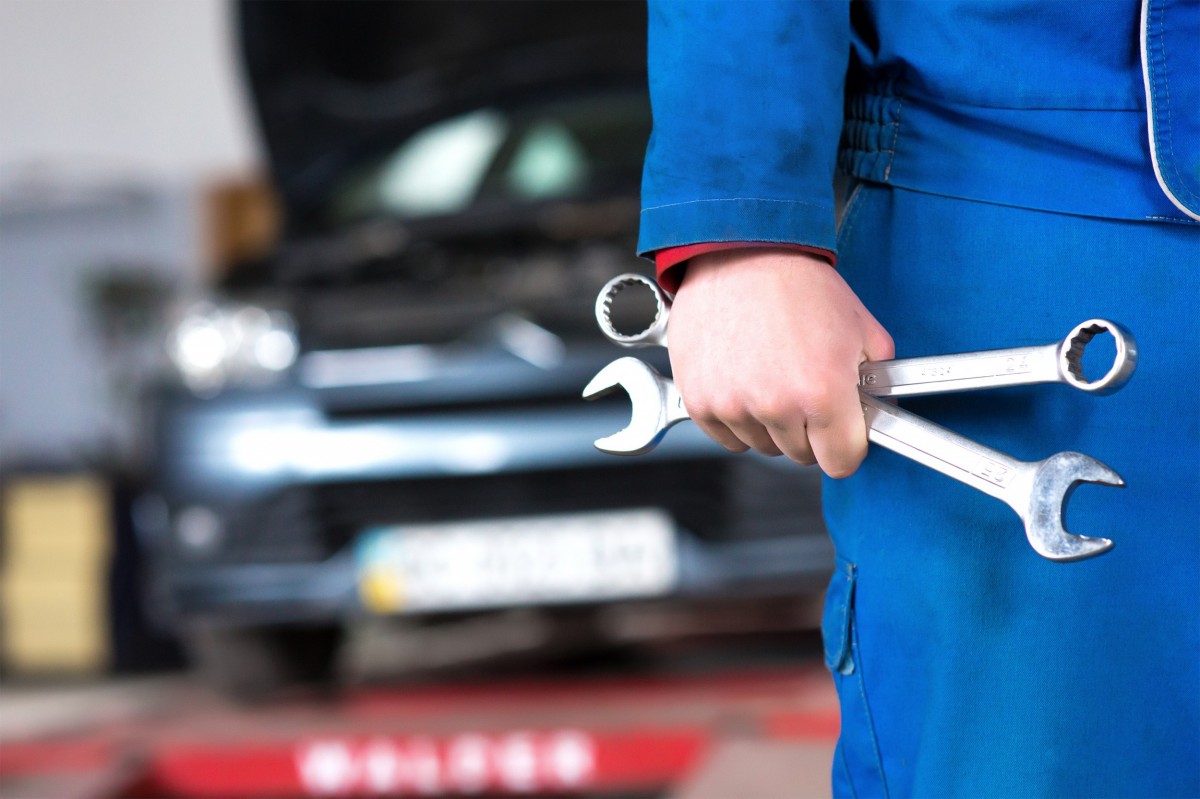 man holding wrenches