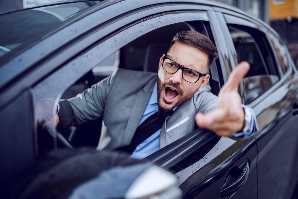 man shouting out window