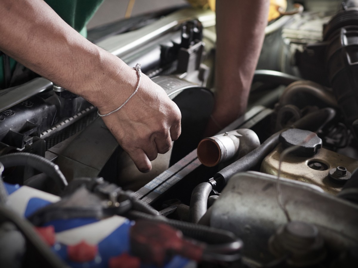 mechanic working on radiator fan