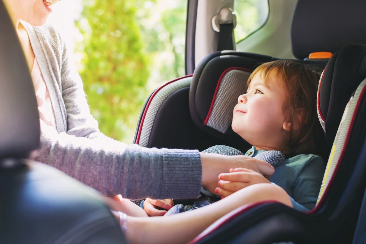 family in car with carseat