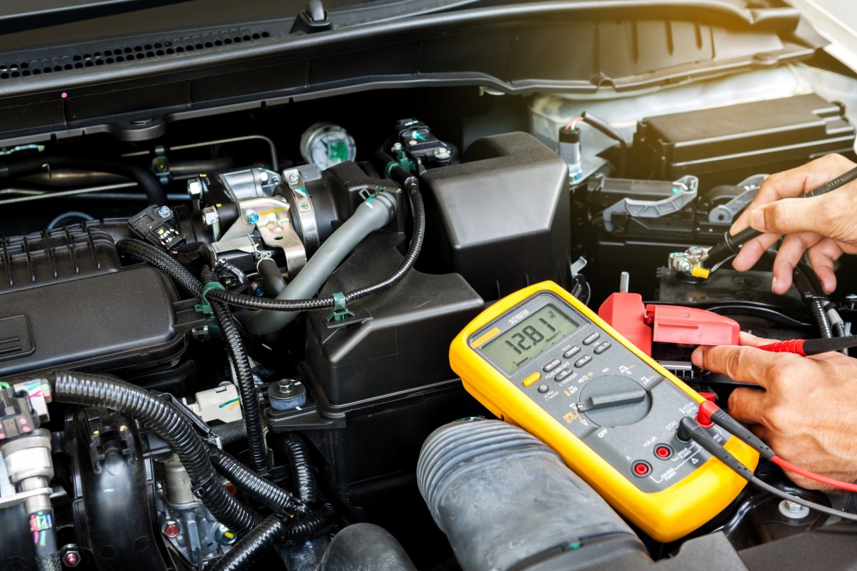 Mechanic testing a car's battery