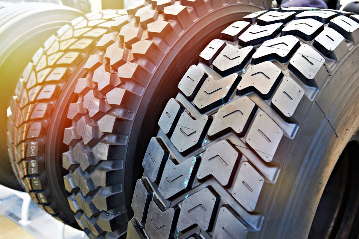 variety of tires sitting on a shelf 