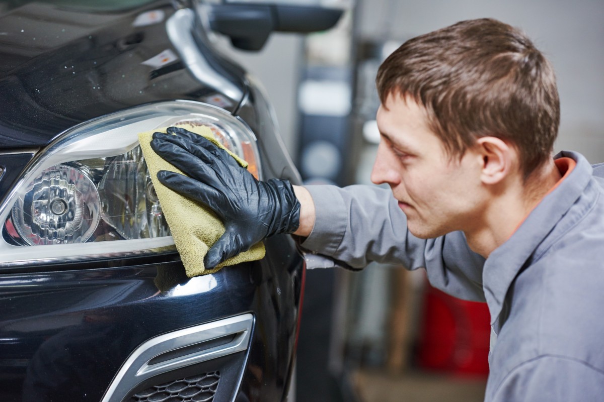 man polishing headlights