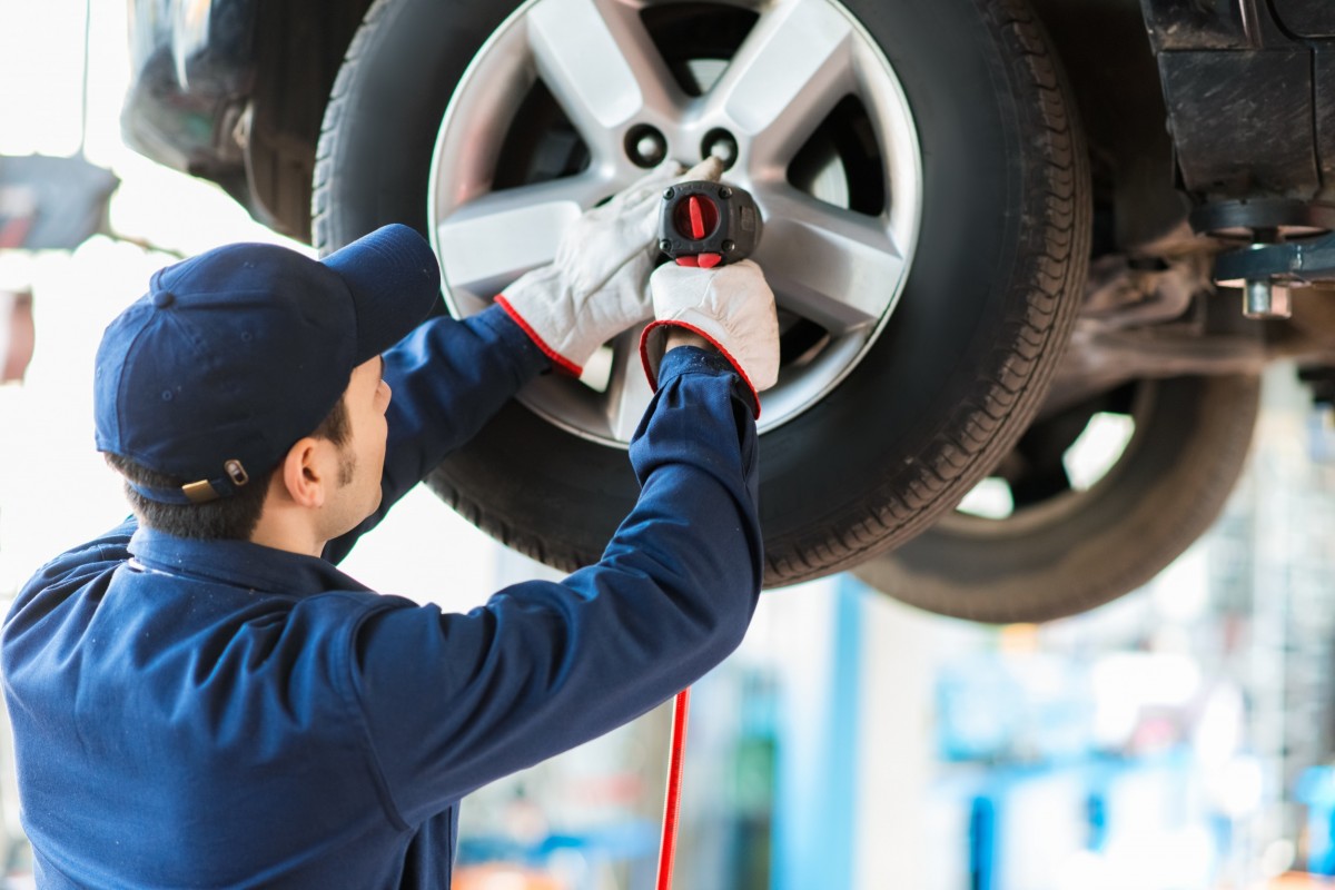 technician rotating tires